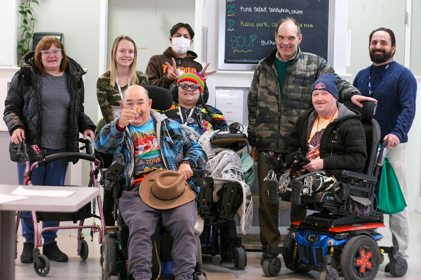Hilltop Brain Injury Services residents and staff gathered together in a campus activity room.