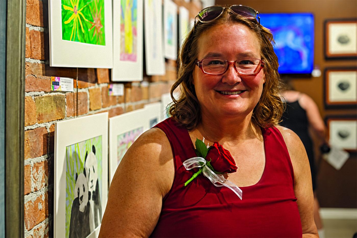 Hilltop Brain Injury Services resident smiling at a local art gallery during a community outing.